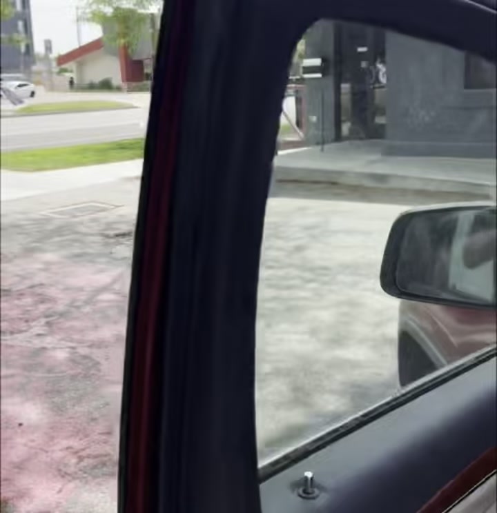 View from inside a vehicle through the driver-side window, looking at the front of Boise Main Co-working Space at 2210 W. Main Street, Boise, Idaho, parked in the 3rd of 13 on-site parking spots