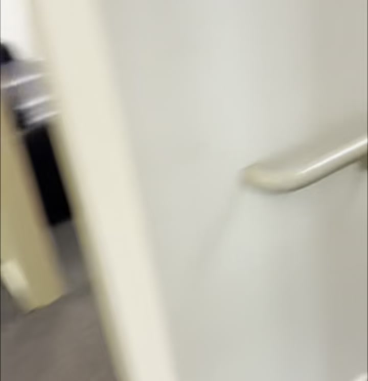 Stairwell descending one flight from the main floor to the basement level of Boise Main Co-working Space, leading into the basement hallway