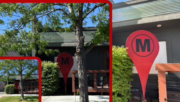 Red map pin in front of the building